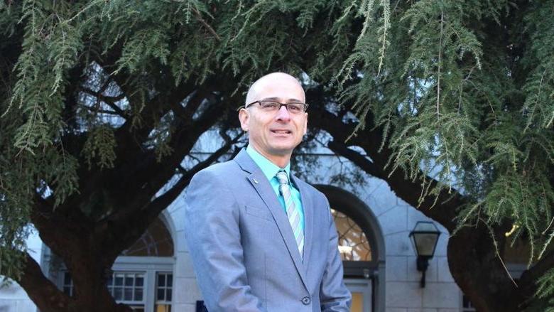 Gary Liquori standing in front of a building